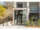 Inviting entryway of a modern brick home with large windows and staircase access at 247 Huntington Ne Rd, Atlanta, GA 30309