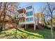 Contemporary three-story home featuring a cantilevered balcony, modern design, and green lawn at 247 Huntington Ne Rd, Atlanta, GA 30309