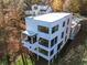 Stunning three-story home with a unique design, featuring a cantilevered balcony and a minimalist aesthetic at 247 Huntington Ne Rd, Atlanta, GA 30309