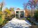 Striking home exterior with large windows offering views of the surrounding autumn foliage at 247 Huntington Ne Rd, Atlanta, GA 30309
