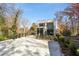 Modern brick home with large windows and a concrete driveway, surrounded by lush greenery at 247 Huntington Ne Rd, Atlanta, GA 30309