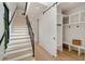Hallway with a staircase, mudroom, light wood floors, and white walls at 247 Huntington Ne Rd, Atlanta, GA 30309