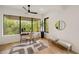 Bright home office with a desk, hardwood floors, oversized windows with nature views, and bench seating at 247 Huntington Ne Rd, Atlanta, GA 30309