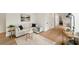 Bright living room featuring a neutral sectional, hardwood floors, stylish rug, and trendy bar cart at 247 Huntington Ne Rd, Atlanta, GA 30309