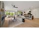 Inviting living area with large windows, a fireplace, and seamless flow to the kitchen and outdoor spaces at 247 Huntington Ne Rd, Atlanta, GA 30309