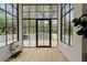 Bright living room features modern windows, light wood floors and views of the outdoor space at 247 Huntington Ne Rd, Atlanta, GA 30309