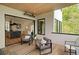 Covered patio offering seamless indoor-outdoor living with views, dining area, and stylish decor at 247 Huntington Ne Rd, Atlanta, GA 30309