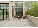 Outdoor patio featuring comfortable seating and large windows overlooking lush greenery at 247 Huntington Ne Rd, Atlanta, GA 30309