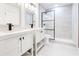 Modern bathroom featuring dual vanities, a glass-enclosed shower, and sleek white tiling, designed for luxury at 5483 Wylstream, Norcross, GA 30093