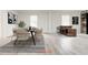 Staged dining area featuring modern table and chairs, stylish bar area, and ample natural light at 5483 Wylstream, Norcross, GA 30093