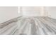 Close-up of gray-wash hardwood flooring in a brightly lit room at 5483 Wylstream, Norcross, GA 30093