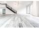 Bright and airy living room with soaring ceilings, large windows, sleek staircase, and modern wood flooring at 5483 Wylstream, Norcross, GA 30093