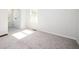 Bright bedroom with neutral carpet, white walls, and natural light coming through the window at 1005 Sims Nw Ave, Atlanta, GA 30318