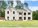 Stately two-story home featuring a light brick facade, a well-manicured lawn, and surrounded by mature trees at 5380 Deer Run Dr, Conyers, GA 30094