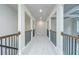 Upstairs hallway featuring architectural columns and wrought iron railing at 5380 Deer Run Dr, Conyers, GA 30094