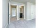 Spacious hallway featuring neutral colors and an open doorway to a bathroom at 5380 Deer Run Dr, Conyers, GA 30094