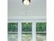 Bright natural light shines through these triple-paned windows looking out onto the wooded property at 5380 Deer Run Dr, Conyers, GA 30094