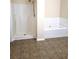 Clean bathroom with a stand-up shower and a separate bathtub at 6398 Shadow Sq, Lithonia, GA 30058