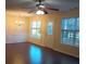 Bright dining room featuring hardwood floors, a stylish chandelier, wainscoting and natural light at 6398 Shadow Sq, Lithonia, GA 30058