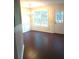 Bright dining room featuring hardwood floors, a stylish chandelier, wainscoting and natural light at 6398 Shadow Sq, Lithonia, GA 30058