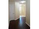 Welcoming entryway with gleaming hardwood flooring and a glimpse of the front door and tiled area at 6398 Shadow Sq, Lithonia, GA 30058