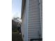 Home exterior featuring light-colored siding, and lush greenery at 6398 Shadow Sq, Lithonia, GA 30058