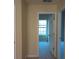 Bright hallway with open doorways leading to rooms with windows and neutral carpet at 6398 Shadow Sq, Lithonia, GA 30058