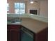 Well-lit kitchen featuring a stainless steel sink and tan countertops at 6398 Shadow Sq, Lithonia, GA 30058