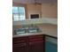 Kitchen area featuring double sink with cherry cabinets and stainless steel appliances offering functionality and style at 6398 Shadow Sq, Lithonia, GA 30058