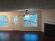 Spacious living room featuring hardwood floors, a fireplace, and natural light from surrounding windows at 6398 Shadow Sq, Lithonia, GA 30058