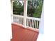 Outdoor porch with wooden floor and white railing that offers a scenic view at 6398 Shadow Sq, Lithonia, GA 30058