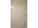 Clean stand-up shower featuring a chrome showerhead and convenient shelving at 6398 Shadow Sq, Lithonia, GA 30058