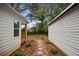 Landscaped backyard with stone pathway, detached garage, and mature trees at 1384 Jefferson Ave, East Point, GA 30344