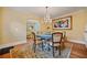 Elegant dining room with hardwood floors, a chandelier, and seating for six at 1384 Jefferson Ave, East Point, GA 30344