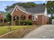 Brick home with a charming front porch and landscaped lawn at 1384 Jefferson Ave, East Point, GA 30344