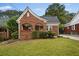 Brick home with a charming front porch and landscaped lawn at 1384 Jefferson Ave, East Point, GA 30344