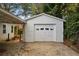 Detached single car garage with white siding at 1384 Jefferson Ave, East Point, GA 30344