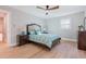 Bedroom with hardwood floors, a bed with green bedding, and nightstands at 2878 London Ne Ct, Marietta, GA 30062