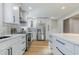 Modern kitchen with white cabinets, stainless steel appliances, and light hardwood floors at 2878 London Ne Ct, Marietta, GA 30062