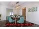 Bright dining room featuring a wood table and teal chairs at 3936 Devonshire Dr, Marietta, GA 30066