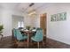 Bright dining room featuring a wood table and teal chairs at 3936 Devonshire Dr, Marietta, GA 30066