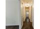 Long hallway with dark hardwood floors and neutral-colored walls at 3936 Devonshire Dr, Marietta, GA 30066