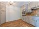 Updated kitchen featuring gray cabinets, granite countertops, and wood-look flooring at 3936 Devonshire Dr, Marietta, GA 30066