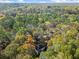 Aerial view of house nestled in a wooded area at 2680 Spalding Dr, Sandy Springs, GA 30350