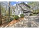 Attached garage with gray doors and landscaping at 2680 Spalding Dr, Sandy Springs, GA 30350