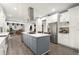 Modern kitchen with stainless steel appliances, a large island with a cooktop, and white cabinetry at 2680 Spalding Dr, Sandy Springs, GA 30350