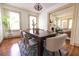 Bright dining room features hardwood floors, a wooden table, and views into the living room at 2791 Pearl St, East Point, GA 30344