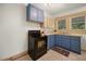 Small kitchen with blue cabinets, black appliances, and tile floor at 2791 Pearl St, East Point, GA 30344