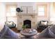 Living room with fireplace and two green chairs at 2791 Pearl St, East Point, GA 30344