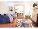 Living room with leather sofa, fireplace, and hardwood floors at 2791 Pearl St, East Point, GA 30344